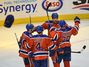 Edmonton Oilers centre Leon Draisaitl (29) celebrates his hat-trick goal with Milan Lucic (27), Mark Letestu (55) and Kris Russell (4) as caps rain down from the fans on the way to a 7-1 win over the Anaheim Ducks at Rogers Place in Edmonton on May 7, 2017. (Ed Kaiser)