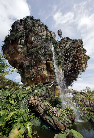 In this Saturday, April 29, 2017 photo, floating mountains are part of the scenery at Pandora-World of Avatar land attraction in Disney's Animal Kingdom theme park at Walt Disney World in Lake Buena Vista, Fla. The 12-acre land, inspired by the “Avatar” movie, opens in Florida at the end of May at Walt Disney World’s Animal Kingdom. It cost a half-billion dollars.(AP Photo/John Raoux)