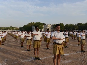 Indian volunteers of the controversial Hindu right-wing group Rashtriya Swayamsevak Sangh (RSS) take part a drill in front of RSS Chief Mohan Bhagwat in Ahmedabad on April 10, 2016. / AFP / SAM PANTHAKY