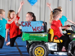 Clara Feeney (left) waves to adoring fans (and quite likely family members) in the back of this four-wheel drive vehicle during the “Car Wash” routine at the Mitchell Gymnastics Club’s year-end showcase last Saturday, May 6 at the Mitchell & District Arena.  ANDY BADER/MITCHELL ADVOCATE
