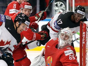 Canada’s Brayden Schenn, left, and Wayne Simmonds, back right, and Belarus’ Mikhail Karnaukhov, front right, look for the puck during world championship play in the AccorHotels Arena in Paris Monday, May 8, 2017. (AP Photo/Petr David Josek)