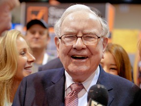 Berkshire Hathaway Chairman and CEO Warren Buffett laughs while touring the exhibit floor at the CenturyLink Center in Omaha, Neb., Saturday, May 6, 2017, where company subsidiaries display their products.  (AP Photo/Nati Harnik)