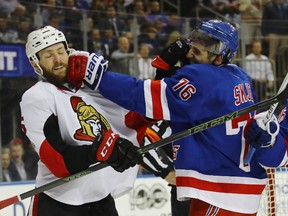 Zack Smith  of the Ottawa Senators and Brady Skjei of the New York Rangers battle during the first period in Game 4 of their series. (Getty Images)