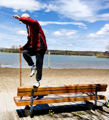 After many successful attempts an adventurous man practices his tightrope walking on a park bench in the Beach on Monday May 8, 2017. Veronica Henri/Toronto Sun/Postmedia Network