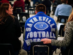 Current players of the Sayreville football team attend a Board of Education meeting to support their team’s coaches on October 21, 2014 in Parlin, New Jersey. The Sayreville War Memorial High School coaching staff was suspended by the school superintendent in the wake of a hazing scandal that involved sexual assault by the school’s football team. (Kena Betancur/Getty Images)