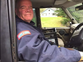 Rob McClenahan lost his home to flooding. He continues to deliver the mail on the street. -