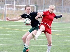 Jaime Lemega of the Confederation Chargers battles for the ball with Brooke Chamberland of the St. Charles Cardinals during seniors girls high school soccer action in Sudbury, Ont. on Monday May 8, 2017. Gino Donato/Sudbury Star/Postmedia Network