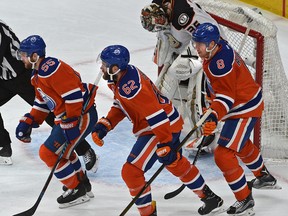 Edmonton Oilers Mark Letestu (55), Eric Gryba (62) and Griffin Reinhart (8) skate past Anaheim Ducks goalie John Gibson as he lowers his head after allowing a third goal in the first period of Game 6 at Rogers Place in Edmonton on Sunday, May 7, 2017. (Ed Kaiser)