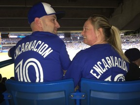 Vince and Lauren Bierworth enjoy Edwin Encarnacion's return game as a Cleveland Indian since leaving the Jays. (JOE WARMINGTON/Toronto Sun)