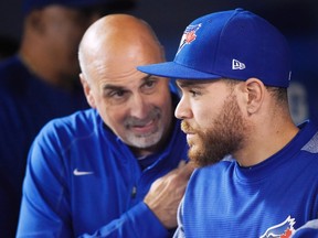 Toronto Blue Jays catcher Russell Martin (right) talks to head athletic trainer George Poulis in the dugout on May 8, 2017. The Blue Jays were dealt another blow on the injury front Monday as Martin was placed on the 10-day disabled list. (NATHAN DENETTE/The Canadian Press)