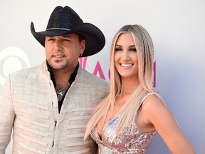 In this April 2, 2017, file photo, Jason Aldean, left, and Brittany Kerr arrive at the 52nd annual Academy of Country Music Awards at the T-Mobile Arena in Las Vegas. Aldean announced on May 8, 2017, that he and Kerr are expecting their first child together. (Photo by Jordan Strauss/Invision/AP, File)