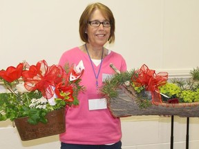 Ann Andrew shows off the prize winning floral displays at the 110th Anniversary Annual General Meeting of District 8 of the Ontario Horticultural Association (OHA).