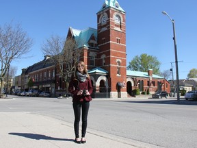 Lindsay Kernohan, museum curator, stands with her camera in front of the Clock Tower, one of the town’s most iconic buildings. She is leading a project that aims to create a record of the municipality in 2017 through images taken by members of the community. JONATHAN JUHA/STRATHROY AGE DISPATCH/POSTMEDIA NETWORK