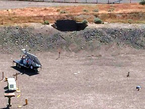 This image provided by the U.S. Department of Energy shows a 20-foot by 20-foot hole in the roof of a storage tunnel at the Hanford Nuclear Reservation near Richland, Wash., Tuesday, May 9, 2017. An emergency was declared Tuesday after the partial collapse of the tunnel that contains rail cars full of radioactive waste. (U.S. Department of Energy via AP)