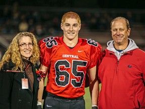 This Oct. 31, 2014, photo provided by Patrick Carns shows Timothy Piazza, centre, with his parents Evelyn Piazza, left, and James Piazza, right, during Hunterdon Central Regional High School football’s Senior Night at the high school’s stadium in Flemington, N.J. (Patrick Carns via AP)
