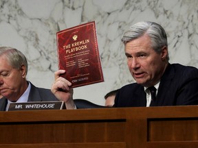 Senate Judiciary Committee member Sen. Sheldon Whitehouse (D-RI) holds up a copy of 'The Kremlin Playbook' while delivering remarks with Sen. Lindsey Graham (R-SC) at the conclusion of a subcommittee hearing on Russian interference in the 2016 election in the Hart Senate Office Building on Capitol Hill in Washington on Monday, May 8, 2017. (Chip Somodevilla/Getty Images)