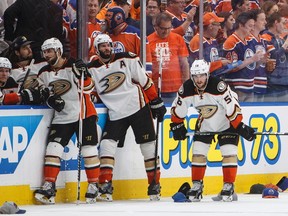 Anaheim Ducks' Andrew Cogliano (7), Ryan Kesler (17) and Nic Kerdiles (58) wait for the hats to be cleaned up after Edmonton Oilers' Leon Draisaitl (29) scored a hat trick during the second period in game six of a second-round NHL hockey Stanley Cup playoff series in Edmonton on Sunday, May 7, 2017.