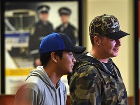 The city is expanding a program that offers free transit aimed at helping homeless individuals and those at high risk of homelessness like Trent Pierre (L) and Elias Thompson both 18, in Edmonton, May 9, 2017.