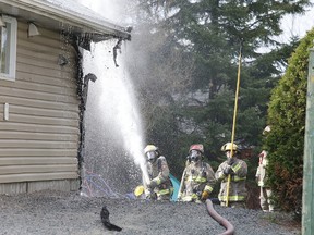Firefighters work to extinguish a blaze at a duplex on Highway 144 in Chelmsford on Tuesday. EMS, Greater Sudbury Police, as well as firefighters, responded to the blaze during the dinner hour. Gino Donato/The Sudbury Star/Postmedia Network