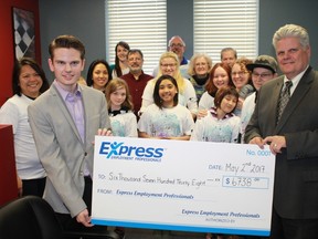 Express Employment Professionals' Garrett and Bruce Hein present a cheque worth $6,738 to representatives of Harmony for Youth, a local non-profit group that assists youth by providing them with music and art lessons. The money came from Express' Impact Project and was given to Harmony on May 2.
CARL HNATYSHYN/SARNIA THIS WEEK