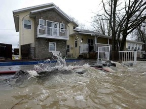 The Ottawa River is nearly level with the deck and swimming pool at Pierre Voisine’s home in Rockland on Sunday. JUSTIN TANG / THE CANADIAN PRESS