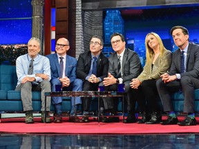 In this photo provided by CBS, host Stephen Colbert, third from right, sits with guests, from left, Jon Stewart, Rob Corddry, John Oliver, Samantha Bee, and Ed Helms during "The Late Show with Stephen Colbert," on Tuesday, May 9, 2017, in New York. It was a rare TV reunion Tuesday as Colbert played host to a gang of his fellow “Daily Show” alums on a special edition of CBS’ “The Late Show.” (Scott Kowalchyk/CBS via AP)