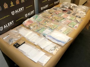Five were charged with child endangerment after nearly $100,000 worth of drugs and cash were seized from two homes in West Lethbridge on May 5. | ALERT Lethbridge/contributed photo