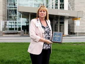 Janet Giroux, who recently earned a de Souza Advanced Practice Nurse designation, shows her prestigious award outside Kingston General Hospital on Tuesday. (Amanda Norris/For The Whig-Standard)
