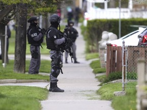 The Toronto Police Emergency Task Force investigates near the scene of a shooting involving two moving vehicles in Scarborough on Wednesday, May 10, 2017. (ERNEST DOROSZUK/TORONTO SUN)