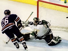 Edmonton Oilers forward Todd Marchant (26) scores the fourth and winning goal for his team as Dallas Stars goalkeeper Andy Moog tries to block the puck, April 29, 1997.