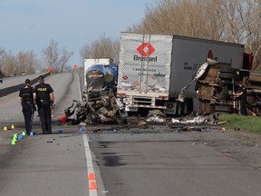 Ontario Provincial Police investigate a crash on Highway 401 west of Joyceville Road that killed four people and hospitalized two others. (Ian MacAlpine/Whig-Standard file photo)