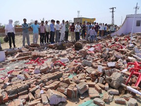 People look at the debris after a building wall collapsed onto guests at a wedding in Bharatpur district, Rajasthan state nearly 200 kilometers (125 miles) south of New Delhi, India, Thursday, May 11, 2017. At least 24 people were killed and many more were injured according to a government official. (AP Photo)