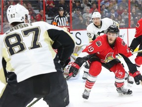 Fredrik Claesson of the Ottawa Senators intensely stares and defends against Sidney Crosby of the Pittsburgh Penguins during second period of NHL action at Canadian Tire Centre in Ottawa, April 05, 2016. (Jean Levac/Postmedia Network)