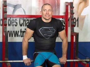 UFC welterweight champion Georges St.-Pierre takes a break during training on on Oct. 28, 2013. (THE CANADIAN PRESS/Ryan Remiorz)