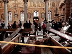 In this Sunday, Dec. 11, 2016, file photo, security forces examine the scene inside the St. Mark Cathedral in central Cairo, following a bombing. Pope Francis meets Friday, April 28, 2017 with the leader of Egypt's Coptic Orthodox Church, part of a two-day trip to the Arab world's most populous country that comes as Islamic State group militants have been increasingly targeting its Christian minority. (AP Photo/Nariman El-Mofty