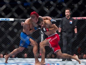 Yair Rodriguez, front right, from Mexico, battles with Nicaragua's Leonardo Morales during a UFC 180 bout in Mexico City on Nov. 15, 2014. (AP Photo/Christian Palma)