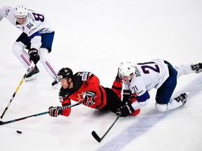 Canada's forward Brayden Point vies with France's forward Antoine Roussel next to France's defender Kevin Hecquefeuille during the IIHF Men's World Championship on May 11, 2017, in Paris. (AFP PHOTO)