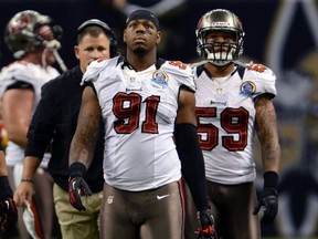 In this Dec. 16, 2012, file photo, Tampa Bay Buccaneers defensive end Da'Quan Bowers (91) walks off the field during a game in New Orleans. (AP Photo)