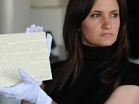 In this June 10, 2008 file photo, a member of staff at Waterstones holds a story written by JK Rowling donated by the author, for the What's Your Story? auction in aid of English PEN and Dyslexia Action, in London. West Midlands Police said Friday May 12, 2017, that the handwritten Harry Potter prequel has been stolen along with some jewelry, during a burglary in Birmingham, central England between April 13 and 24. (Joel Ryan/PA via AP, File)