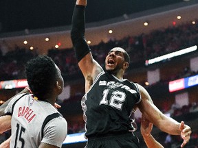 San Antonio Spurs forward LaMarcus Aldridge (12) dunks as Houston Rockets center Clint Capela (15) watches during the second half in Game 6 of an NBA basketball second-round playoff series, Thursday, May 11, 2017, in Houston. San Antonio won 114-75. (AP Photo/Eric Christian Smith)