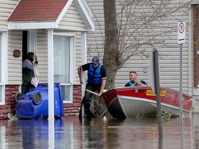 Emergency crews drop off a lady at her house on Rue Saint-Louis in Gatineau Thursday May 11, 2017. Waters have gone down about 6 more inches over night.   Tony Caldwell