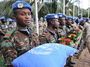 UN peacekeeping force soldiers carry cushion and flowers at Bamako on February 17, 2016, during the last tribute to seven Guinean UN soldiers killed. AFP / HABIBOU KOUYATEHABIBOU KOUYATE/AFP/Getty Images