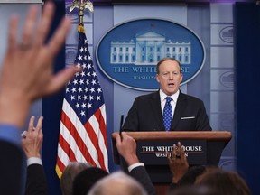 Reporters raise their hands with questions for White House Press Secretary Sean Spicer speaks during the daily briefing in the Brady Briefing Room of the White House on May 9, 2017 in Washington, DC. / AFP PHOTO / Mandel NganMANDEL NGAN/AFP/Getty Images