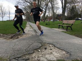 Runners pass through Breakwater Park in Kingston on Thursday. A planned rebuild of the park includes a new multi-use path. (Elliot Ferguson/The Whig-Standard)