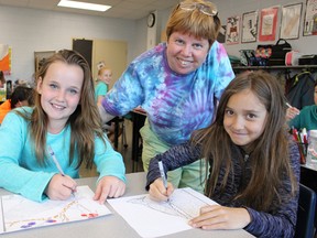 Errol Village teacher Alison Feniak is pictured here with Grade 4 students Carly Jewell and Carley General in her classroom Friday. Feniak has been named Energy Educator of the Year -- a Canada-wide honour -- for her ongoing commitment to environmental education. (Barbara Simpson/Sarnia Observer)