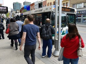 Transit riders crowd around buses on Dundas Street at Richmond Street in London, Ontario on Thursday May 11, 2017. (MORRIS LAMONT, The London Free Press)