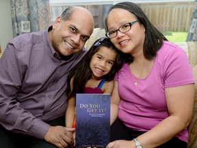 Lin-Pei De Souza, with daughter Genevieve and husband Ivan, wrote a book about her experience battling cancer while giving birth to her daughter. (MORRIS LAMONT, The London Free Press)