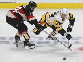 Ottawa Senators defenceman Mark Borowiecki tries slow down Pittsburgh Penguins forward Patric Hornqvist during NHL action on Jan. 12, 2017. (Tony Caldwell/Postmedia)