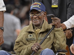 In this March 23, 2017, file photo, Richard Overton leaves the court after a special presentation honoring him as the oldest living American war veteran, during a timeout in an NBA basketball game between the Memphis Grizzlies and the San Antonio Spurs. Overton was honored by his hometown of Austin, Texas, on his 111th birthday on May 11, 2017. (AP Photo/Darren Abate, File)