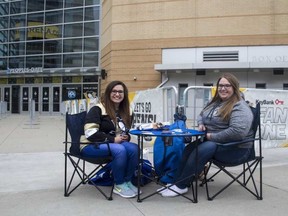 Sam Witucki, left, and Caitlynn Cook, both 22, were the first fans to show up at PPG Paints Arena in Pittsburgh, at 10 a.m. Saturday, nine hours before Game 1 of the Eastern Conference semifinals. They plan on watching the game on one of the screens outside. BRUCE DEACHMAN / POSTMEDIA NETWORK